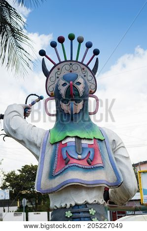 Quito, Ecuador - 28 APRIL, 2015 Stoned sculpture with a hat of the diablada festival, located in the valley of Los Chillos.