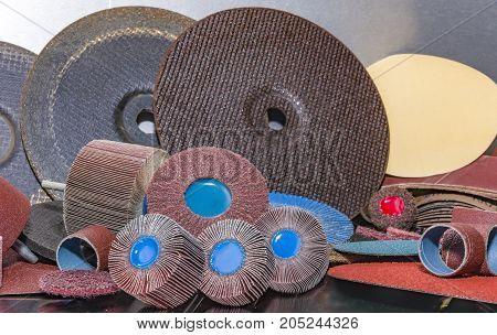 A pile of color abrasive sandpaper for metal working sandpaper for metal working
