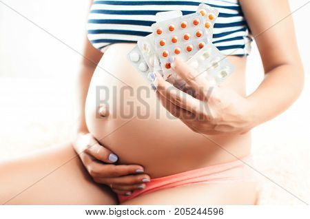 Pregnant Girl In The Hands Holding A Lot Of Pills