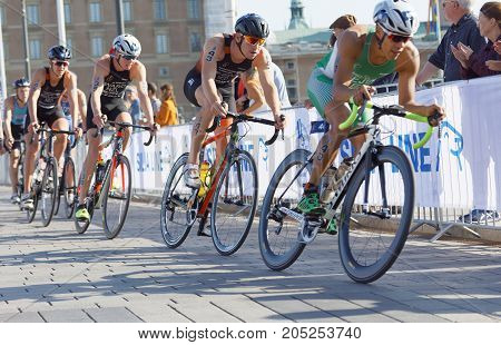 STOCKHOLM - AUG 26 2017: Back of group of colorful triathlete cyclists in the Men's ITU World Triathlon series event August 26 2017 in Stockholm Sweden