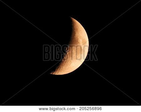 Photo of moon phase catching craters on it's surface