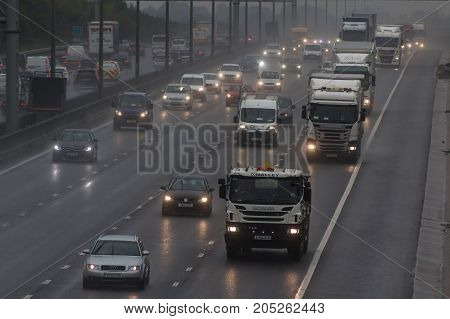 Redbourn UK - September 21 2017: Traffic on busy British motorway M1 in a bad rainy weather.