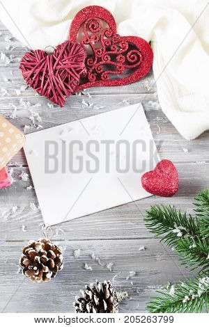Christmas greeting card with Christmas decorated with green twigs fir trees on a gray wooden background copy space flat lay