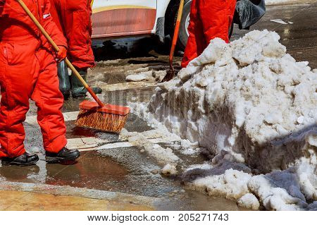Workers Sweep Snow From Road In Winter. Cleaning Road From Snow Storm