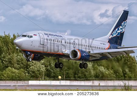 Pulkovo Saint-Petersburg Russia - August 10 2017: Boeing 737-500 VP-BKU Nordavia - Regional Airlines is landing on the runway. Against the background of a blue cloudy sky