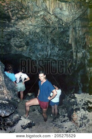 TONGATAPU / TONGA - CIRCA 1990: Spelunkers explore a limestone cave on the east side of the island of Tongatapu.