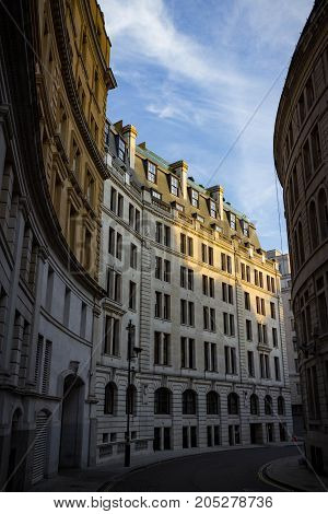 Vertical shot of the magnificent architecture of a curved street in London England at Sunset.