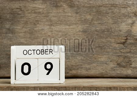 White block calendar present date 9 and month October on wood background (Day of fire prevention hangul in south korea)