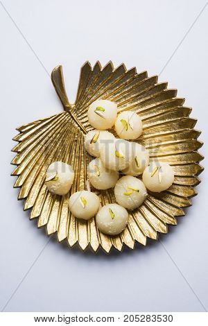 Stock Photo of Rasgulla or sponge Ras Gulla, It is made from ball shaped dumplings of chhena and semolina dough, cooked in light syrup made of sugar.
