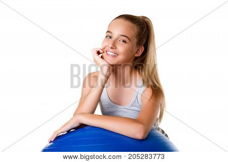 cheerful young girl exercising with exercise ball during workout close upisolated