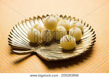 Stock Photo of Rasgulla or sponge Ras Gulla, It is made from ball shaped dumplings of chhena and semolina dough, cooked in light syrup made of sugar.