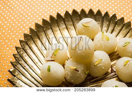 Stock Photo of Rasgulla or sponge Ras Gulla, It is made from ball shaped dumplings of chhena and semolina dough, cooked in light syrup made of sugar.