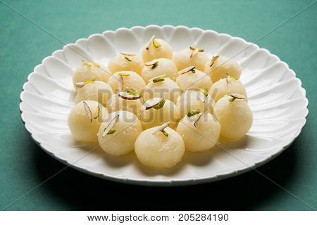 Stock Photo of Rasgulla or sponge Ras Gulla, It is made from ball shaped dumplings of chhena and semolina dough, cooked in light syrup made of sugar.