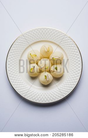 Stock Photo of Rasgulla or sponge Ras Gulla, It is made from ball shaped dumplings of chhena and semolina dough, cooked in light syrup made of sugar.