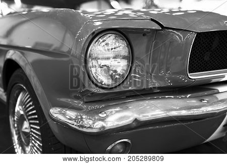 Sankt-Petersburg Russia July 21 2017: Front view of Classic retro Ford Mustang GT.Car exterior details. Headlight of a retro car. Black and white. Photo Taken on Royal Auto Show July 21