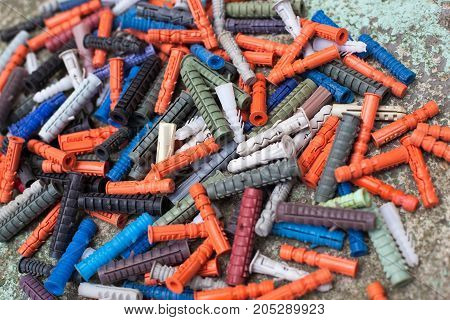 large number of multicolored dowels close-up on the cocrete background