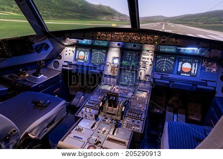 A view of the cockpit of a large commercial airplane a cockpit trainer. Cockpit view of a commercial jaircraft cruising