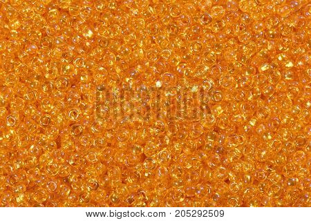 Close up of bright orange seed beads. High resolution photo.