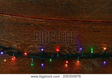 Christmas rustic background - vintage planked wood with lights and free text space.