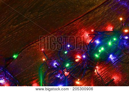 Christmas rustic background - vintage planked wood with lights and free text space.