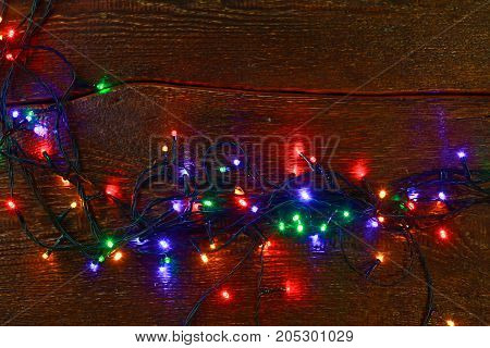 Christmas rustic background - vintage planked wood with lights and free text space.