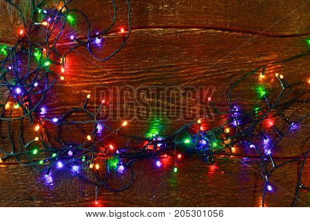 Christmas rustic background - vintage planked wood with lights and free text space.