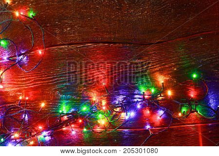 Christmas rustic background - vintage planked wood with lights and free text space.