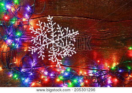 Christmas rustic background - vintage planked wood with lights and free text space.