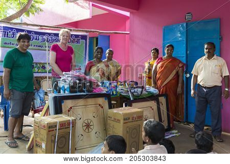 PONDICHERY PUDUCHERY INDIA - SEPTEMBER 04 2017. Outdoor meeting of the children of the school with uniforms sitting on the floor waiting for sport equipments as a gift from an association.