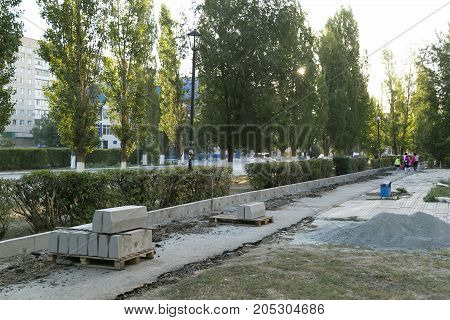 The repair of the road. Pictures of repairing of pedestrian sidewalk. Setting the border