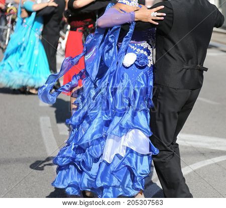 Woman With Long Blue Dress Dancing With A Man On The Street