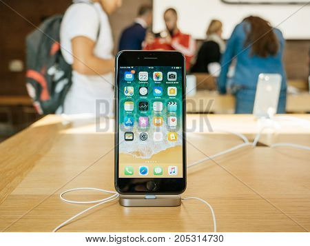 PARIS FRANCE - SEP 22 2017: New iPhone 8 and iPhone 8 Plus in Apple Store with home screen desktop apps and customers in the background