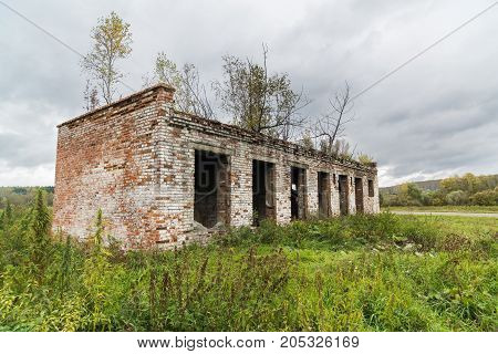 The old destroyed cowshed of the Soviet period in Russia
