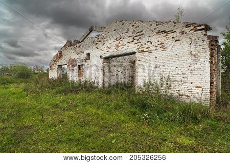 The old destroyed cowshed of the Soviet period in Russia