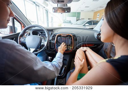 The beautiful couple chose a new car for themselves. The concept of buying a new car.