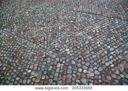 Cobblestone Pavement located on the Slottsbacken street near the Royal Palace in Stockholm Sweden