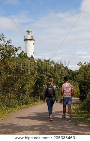 Byxelkrok Sweden - August 22 2017: A couple walking towards the lighthouse Lange Erik at the Swedish province of Oland north end.