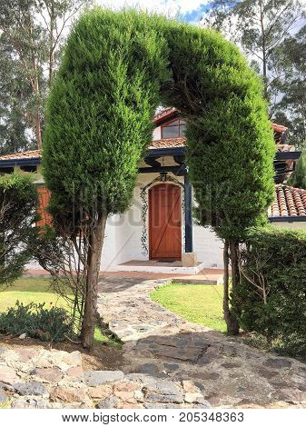 Arch of trees at the entrance to cottage