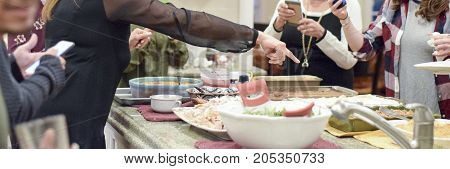 People Serving Themselves Thanksgiving Dinner