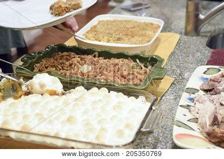 People Serving Themselves Thanksgiving Dinner