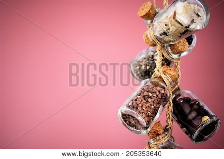 Collection of grain products, lentils, soybeans and red beans in storage jars over on free background. Quinoa, bulgur and couscous cereals. Vegetarian and