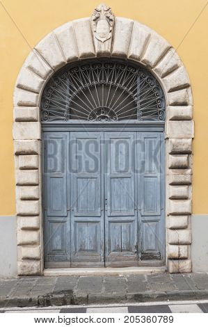 An old marble portal in Carrara Italy.