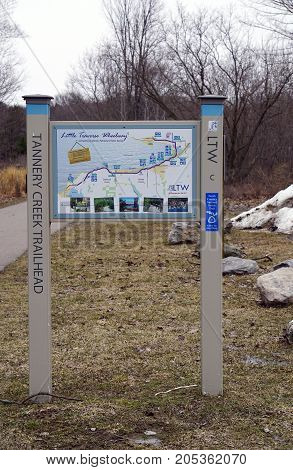 BAY VIEW, MICHIGAN / UNITED STATES - MARCH 30, 2017: A map, posted at the Tannery Creek Trailhead, provides information on public amenities available along the Little Traverse Wheelway, which connects, Charlevoix, Petoskey and Harbor Springs.