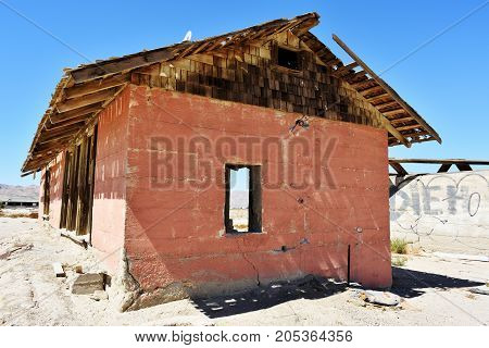 Weathered wooden structure in the desert. Red and brown colors.
