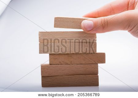Hand Holding Wooden Domino