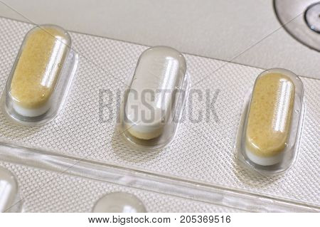 Pills for medical treatment. Pharmaceutical type images showing a verity of pills / capsules.