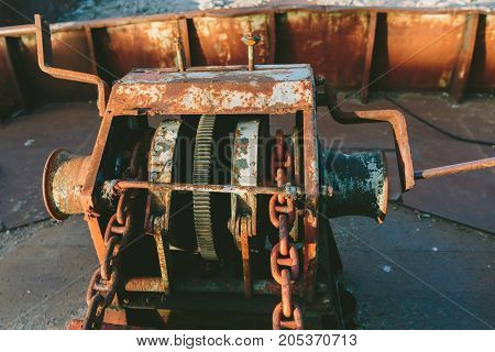 Old rusty anchor lifting mechanism on the ship close-up