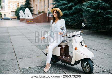 Young Beautiful Sexy Woman Sitting On A Scooter Outdoor