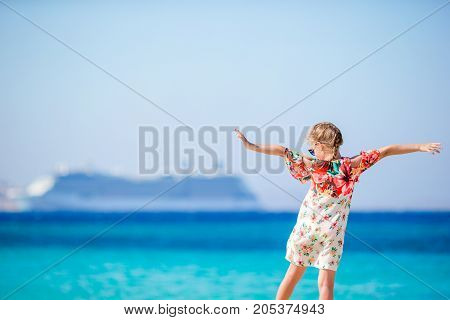 Adorable little girl at tropical beach on vacation