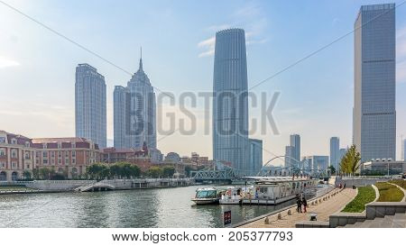 Tianjin, China - Nov 1, 2016: Commercial skyline across the Haihe River. Buildings in contrasting modern and old architectural style.